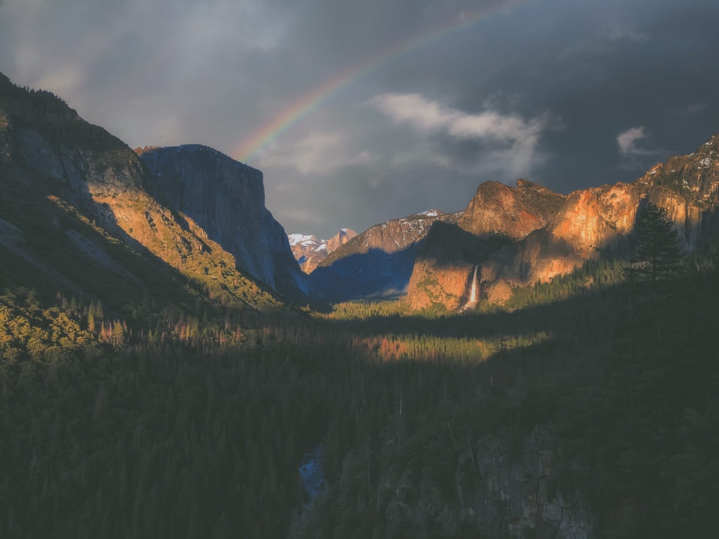 Rainbow casts over Yosemite Valley.